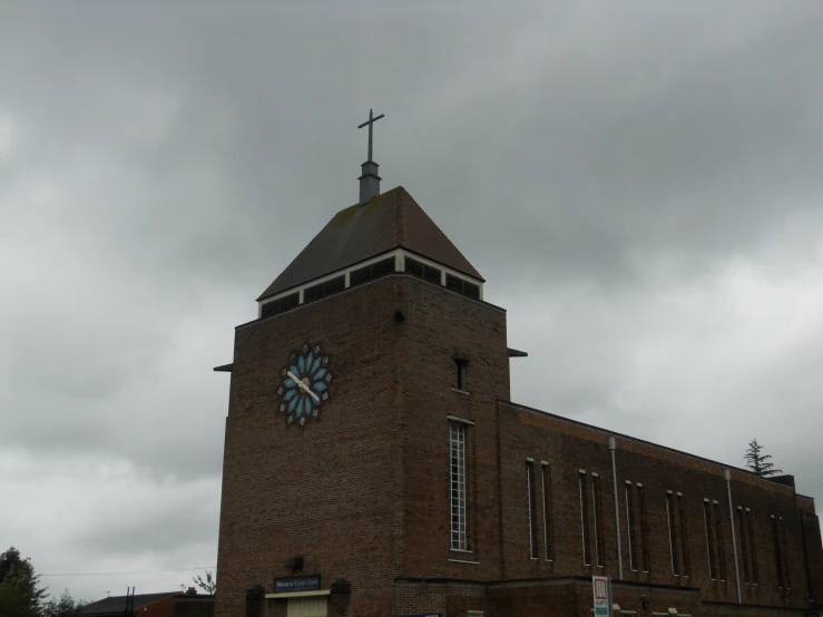 a large brick church building with a clock on the top of it