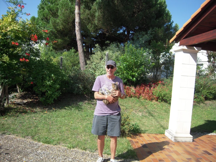 a man with a baseball glove on the ground in front of a fence