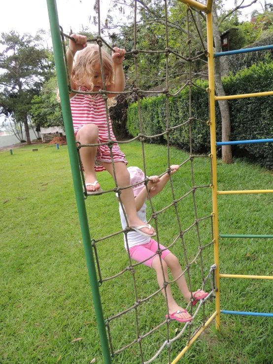 two s on a slide at the park