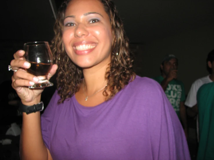 a woman is holding a glass of wine