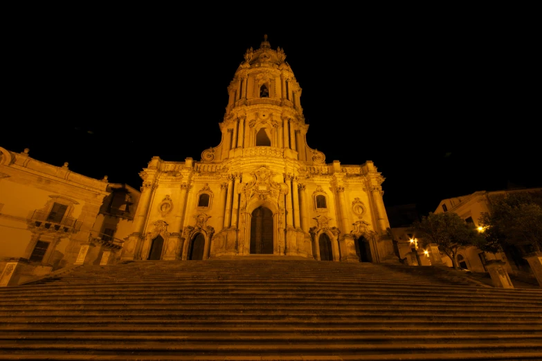 the steps lead up to the front entrance of a large building