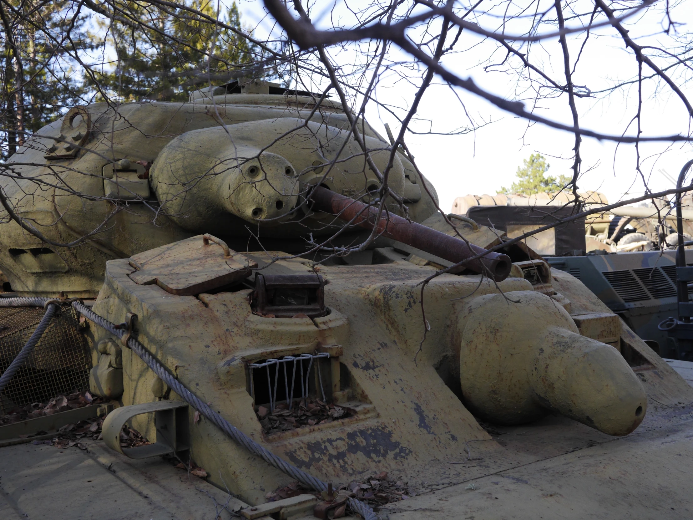 some type of tank near an fence and a tree