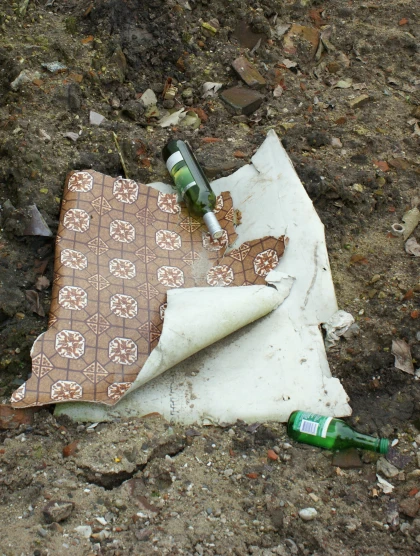 an outdoor table with a brown bag and bottle on it