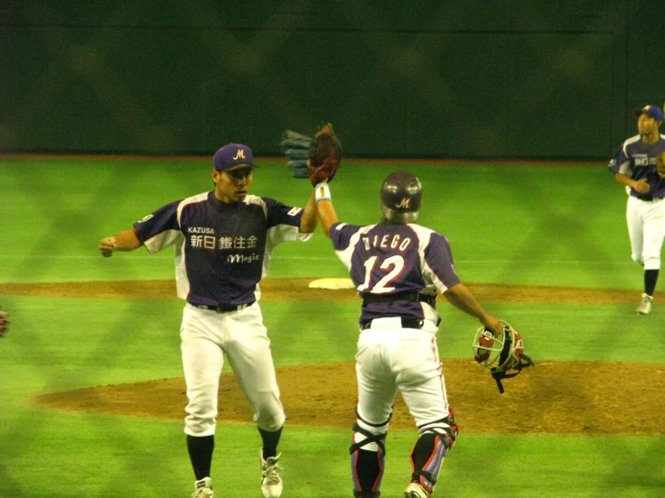 the two baseball players are greeting each other