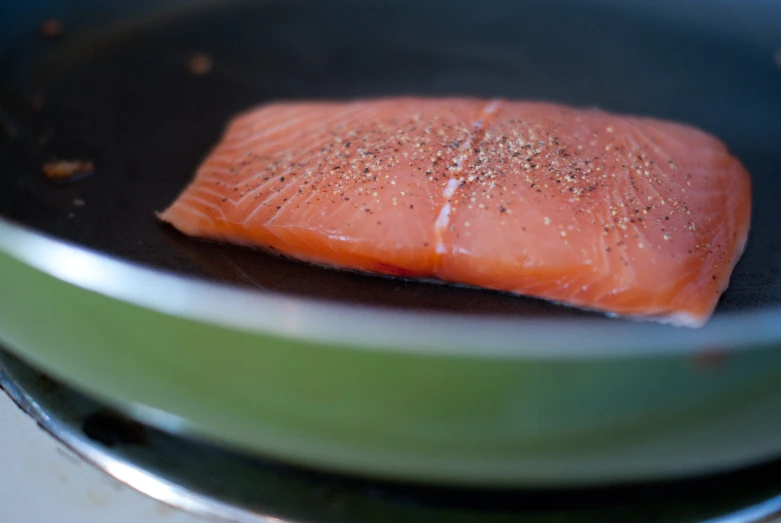 a small piece of salmon in a wok cooking in water