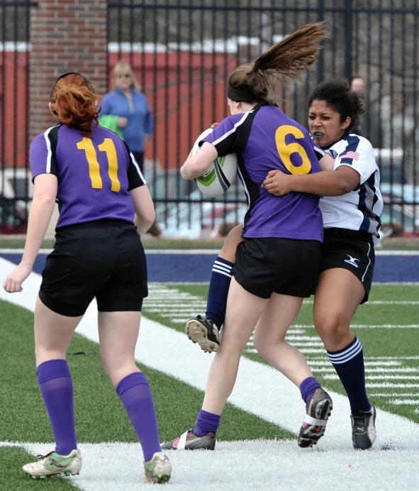 a group of young people playing soccer against each other