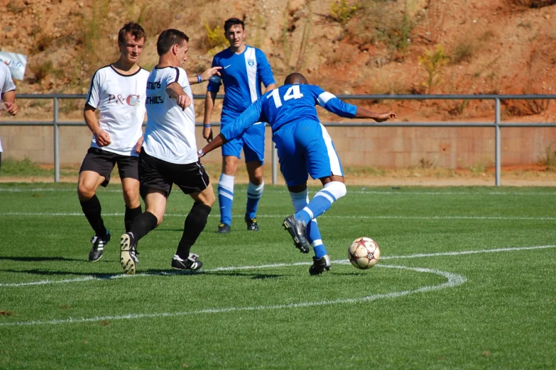 men playing soccer on a green grass field