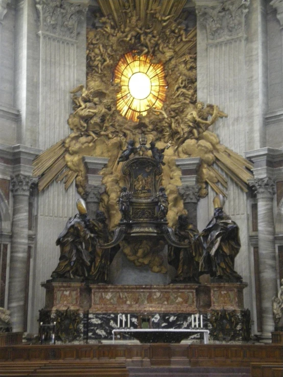 statue is setting inside of the cathedral with an ornate gold dome