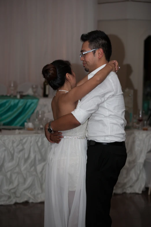 man and woman dance at their reception in a ballroom