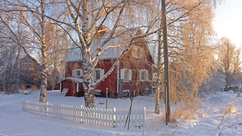 an old house sits alone in the snow