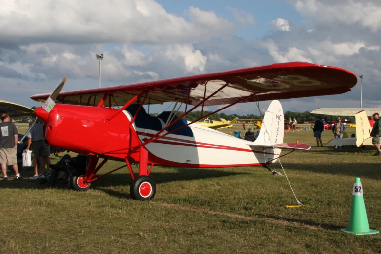 two men are standing beside an airplane