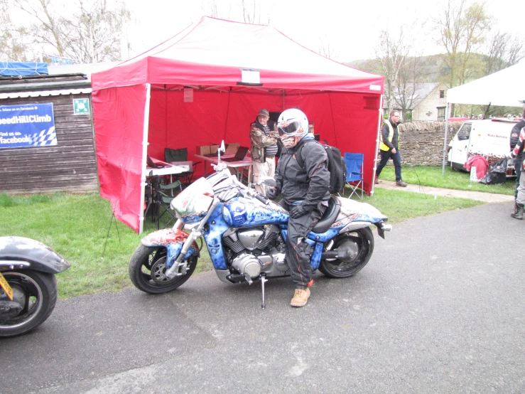 a motorcycle is parked next to a tent