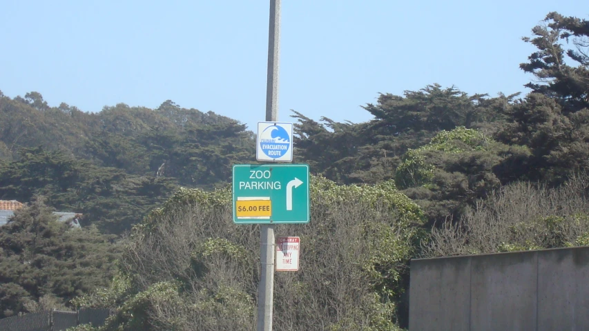 a sign on a pole on the side of a road