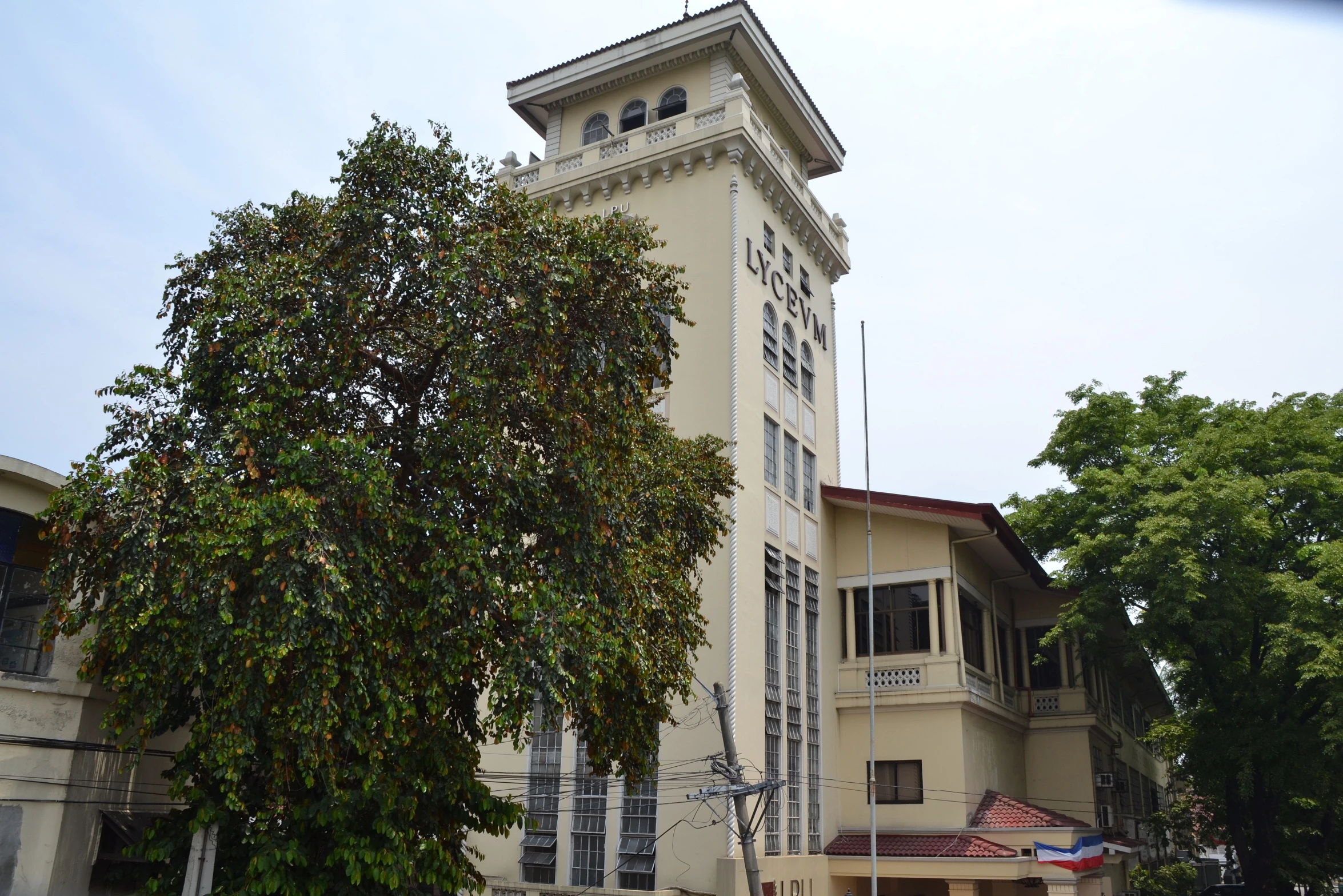 the outside of a large white building with an outside balcony