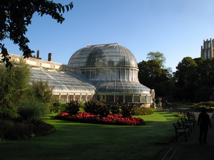 a glass house that is built into a park