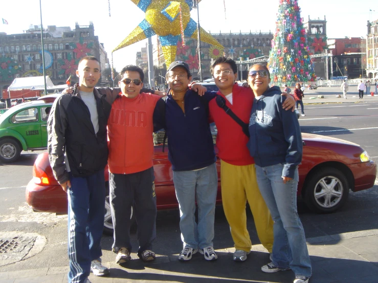 the boys pose for a picture in front of a star on a pole