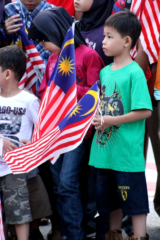 a group of children are standing around with flags