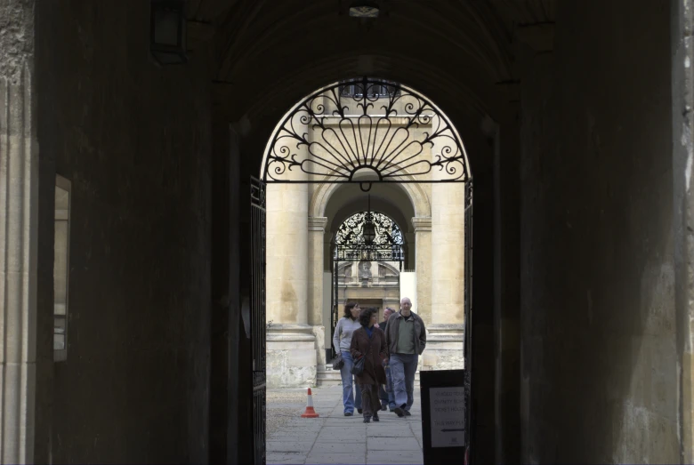 a group of people walk through the middle of a courtyard