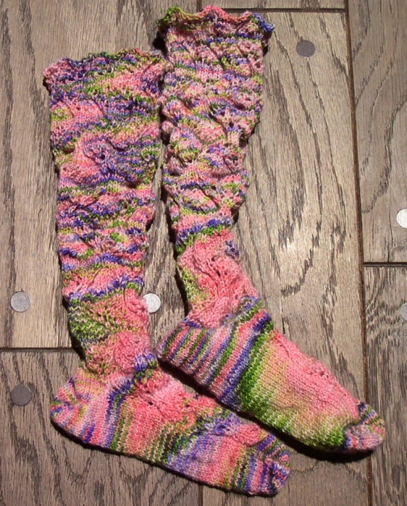 the knit legwars are lined with pink and purple striped yarn