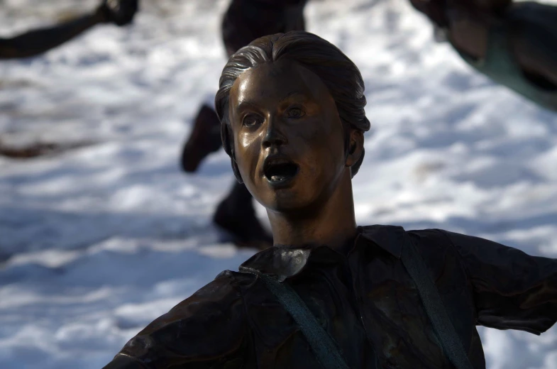 statue of a boy in the middle of snow