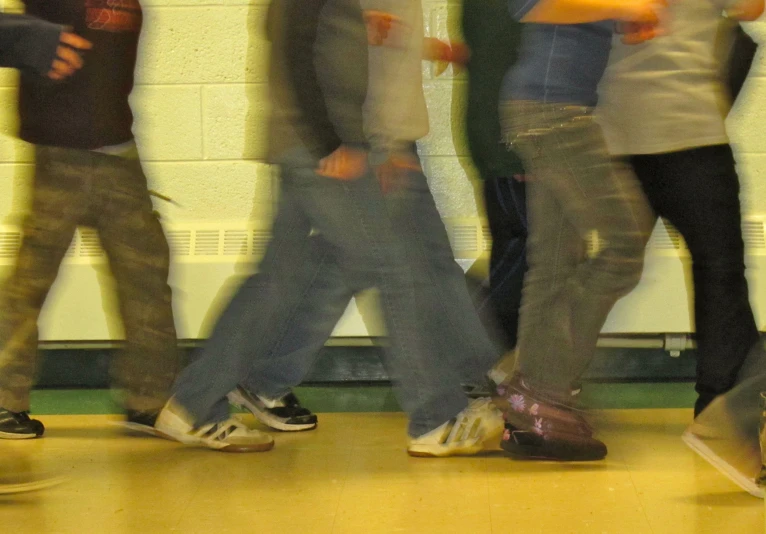 the people stand side by side against a wall