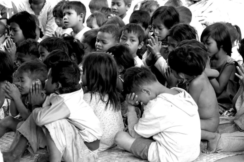 several children are sitting and posing for a po