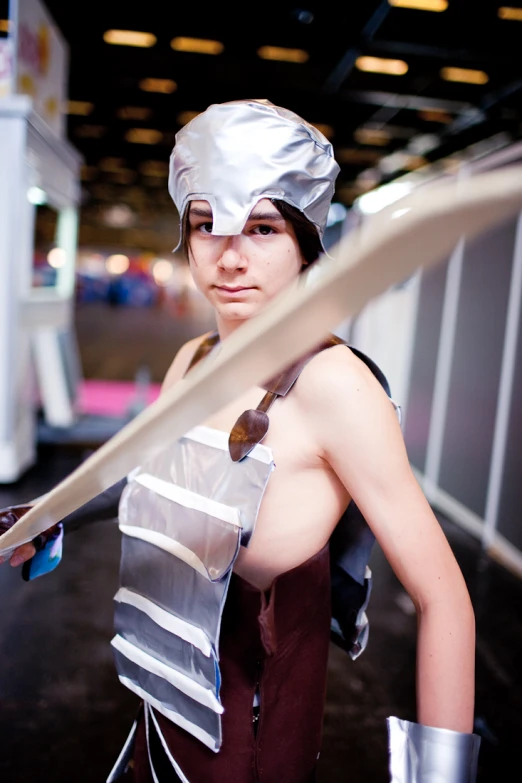 woman in costume posing while holding large sword