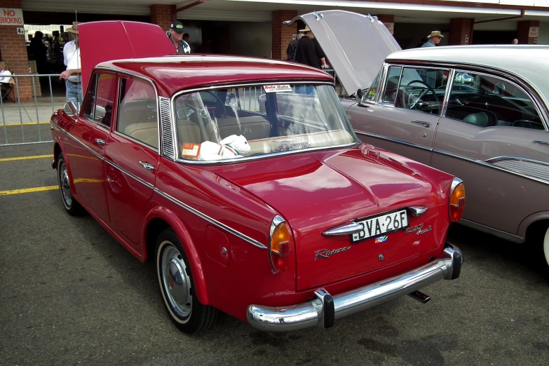 several classic cars parked on the street in a parking lot