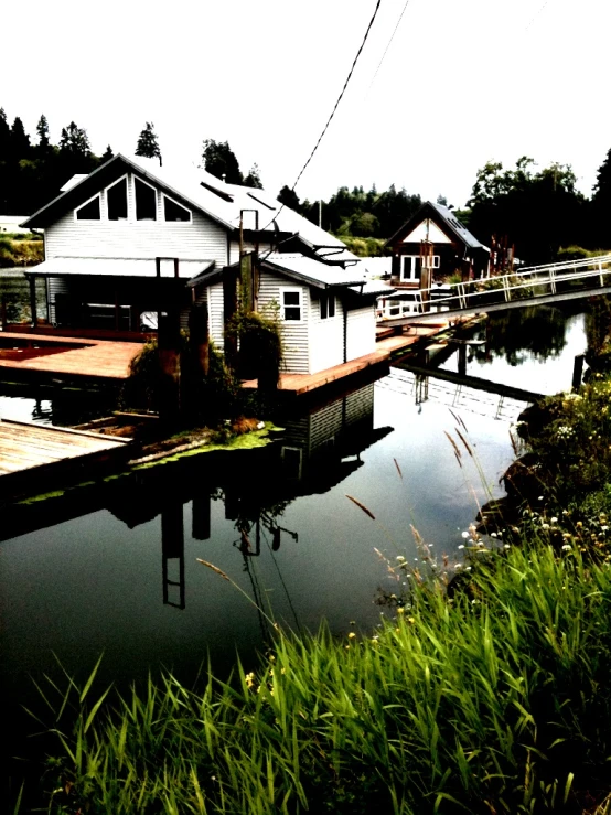 a small marina on a lake is surrounded by small houses