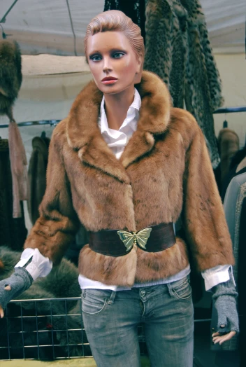 a woman's fur coat is being displayed on a mannequin's head