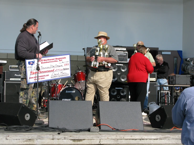 several people on stage playing instruments and singing