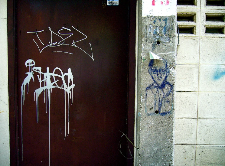 a door with white spray paint and graffitti on it