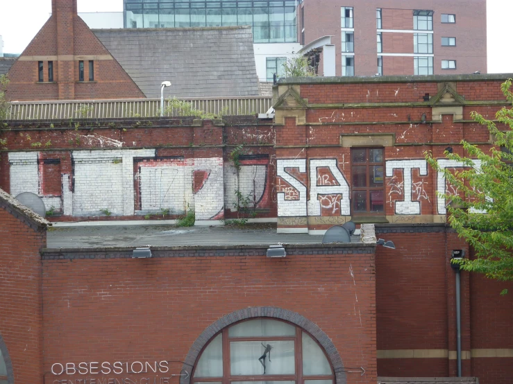 there are some red brick buildings and a tree