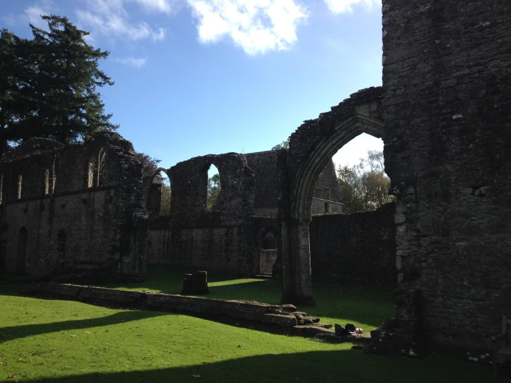 view of the inside of a ruins with grass in front