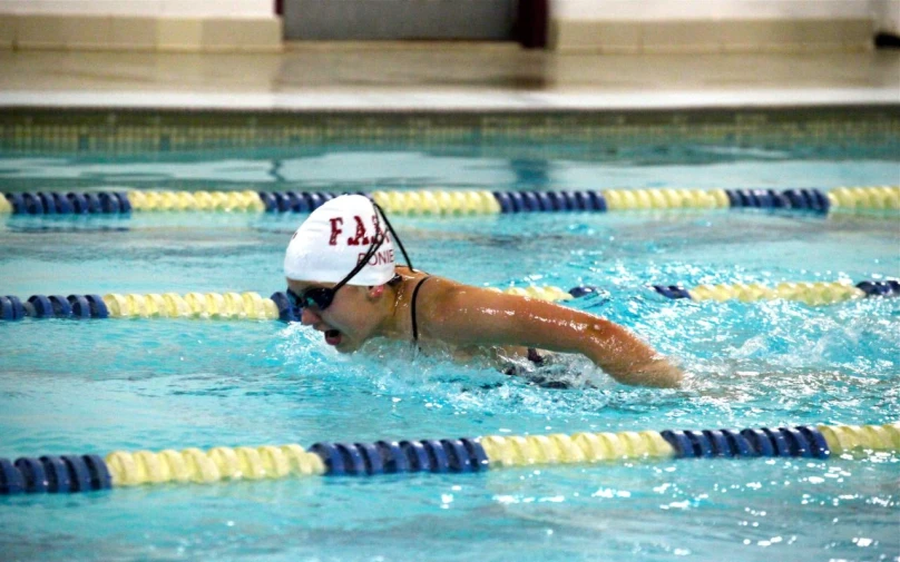 a person swims in a swimming pool