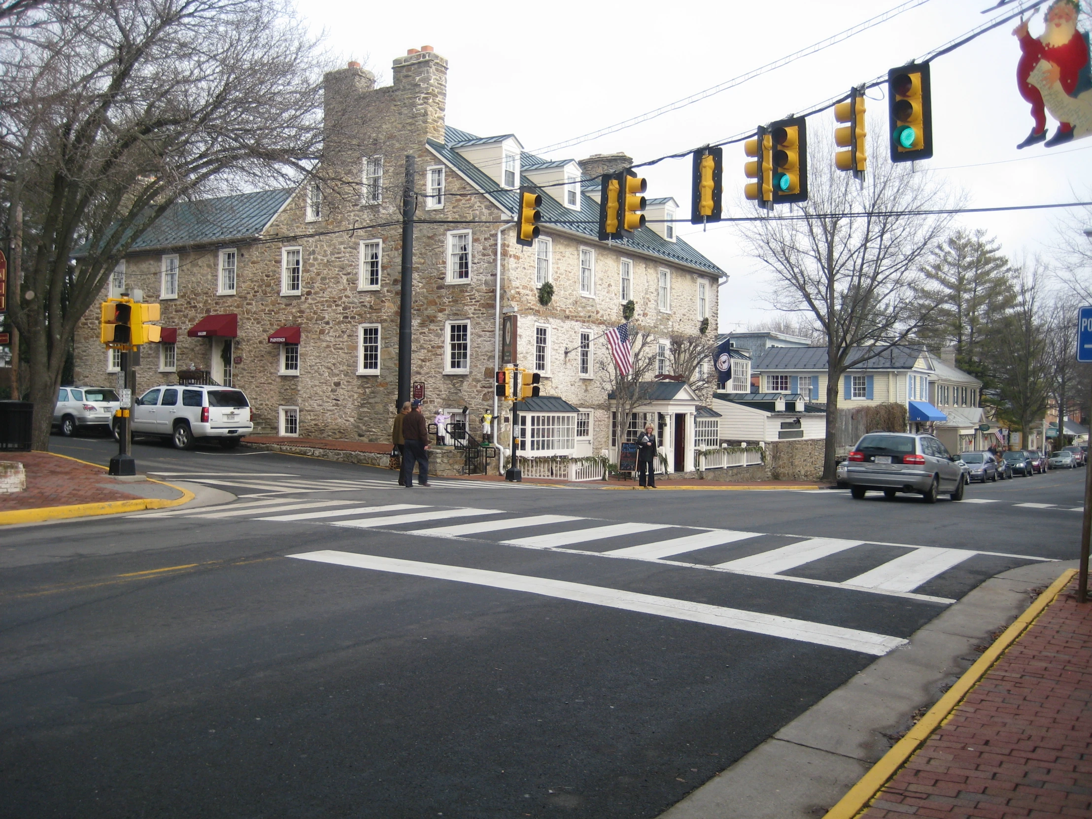 a traffic light on a street with an old stone building