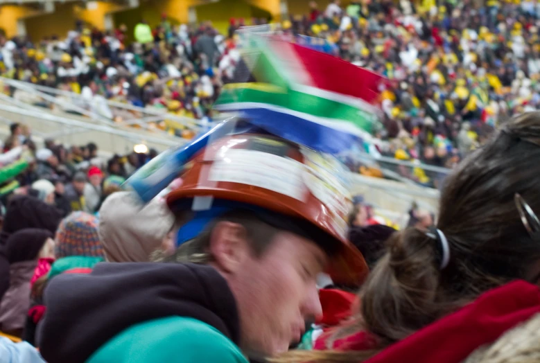 many people with hats on in an arena