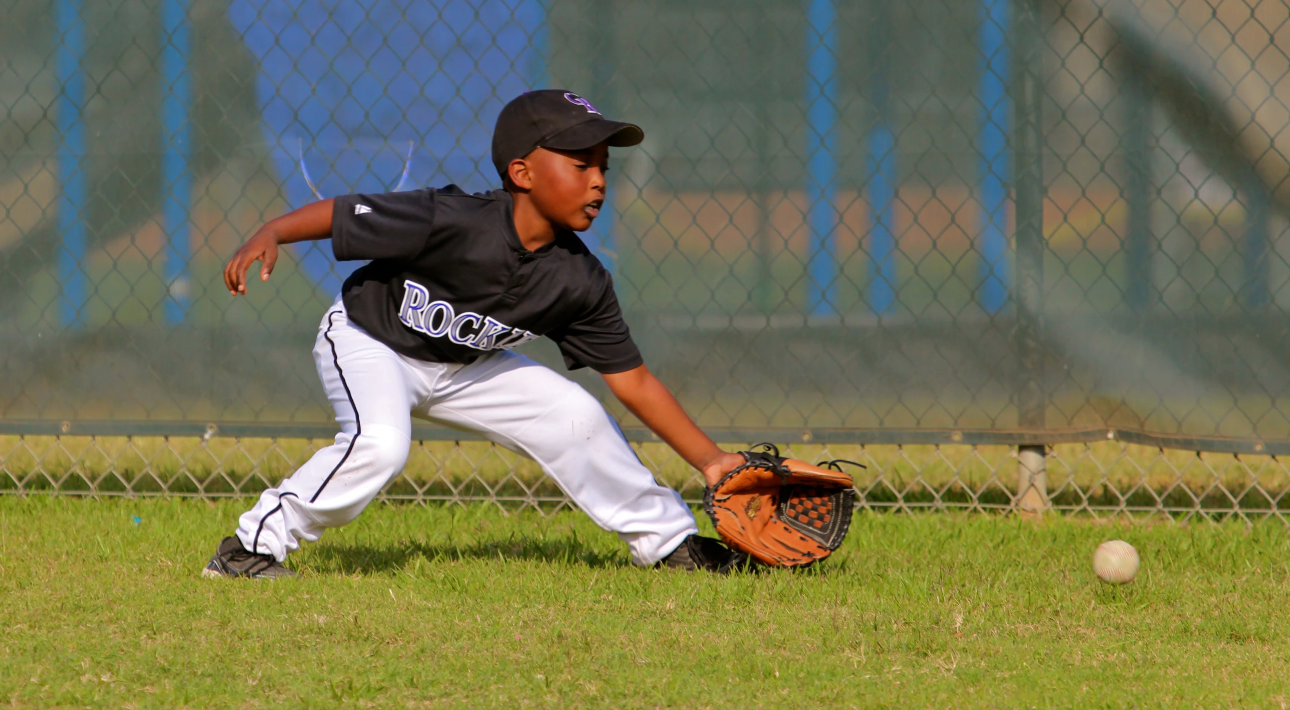 a  playing baseball getting ready to catch a ball