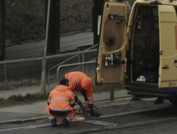 two repair workers are working on a city street