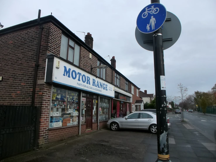 a small brick building with a sign for an old bicycle shop