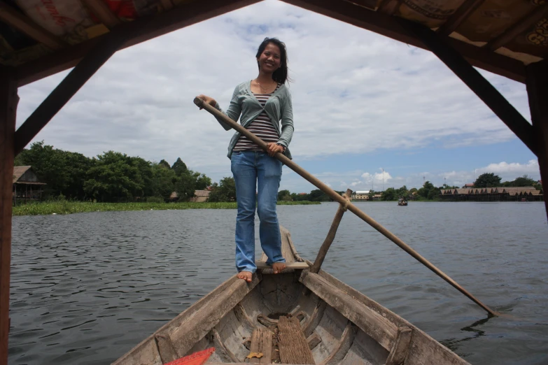 a woman is standing in a boat and looking back