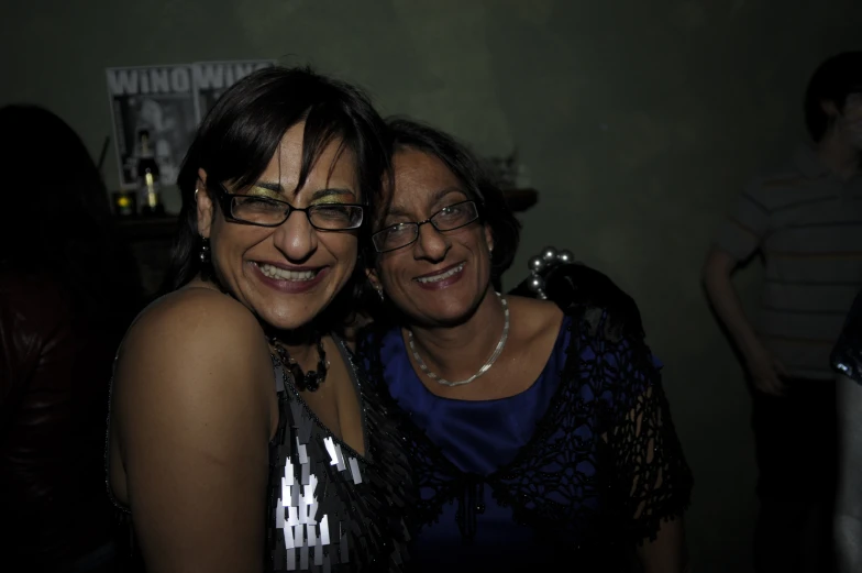 two women smiling and posing for the camera