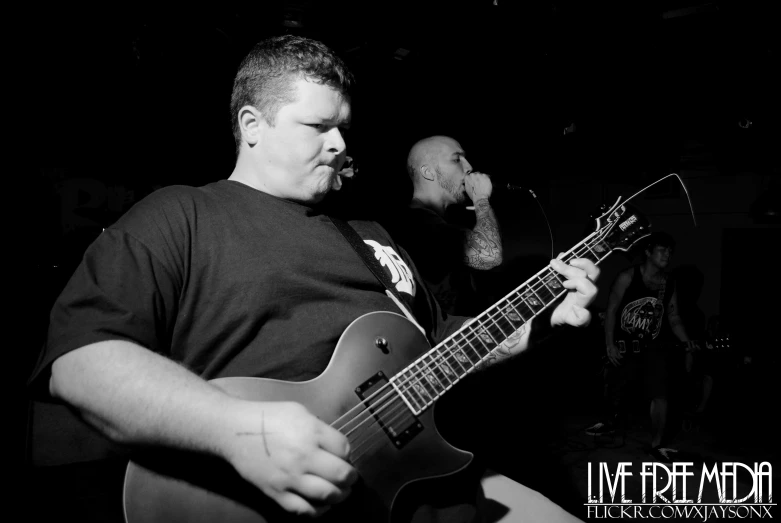 a man that is standing up with a guitar