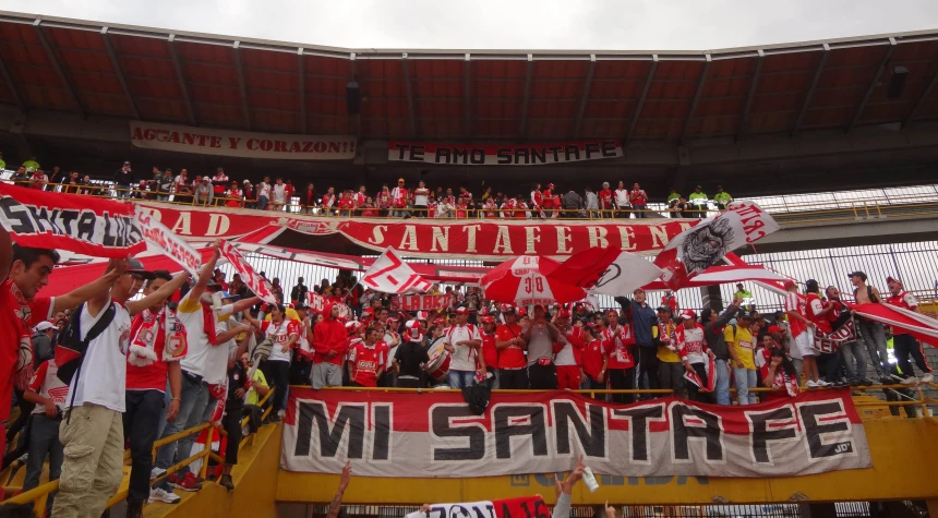 a stadium full of fans celeting with a large banner