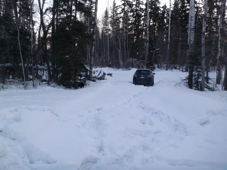 a car is sitting on the snowy road