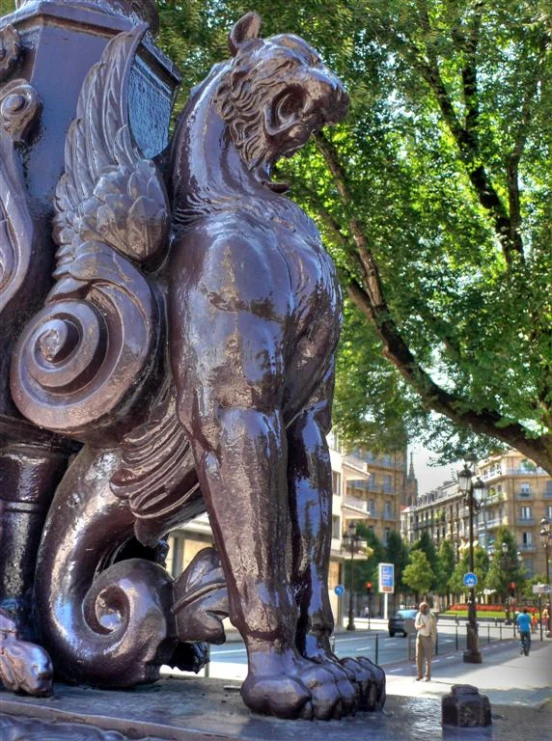 an ornate statue of a lion on a street