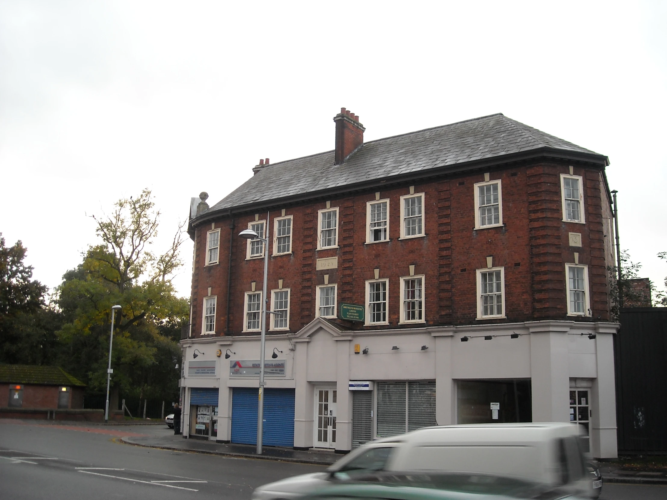 an old brick building with many windows on top