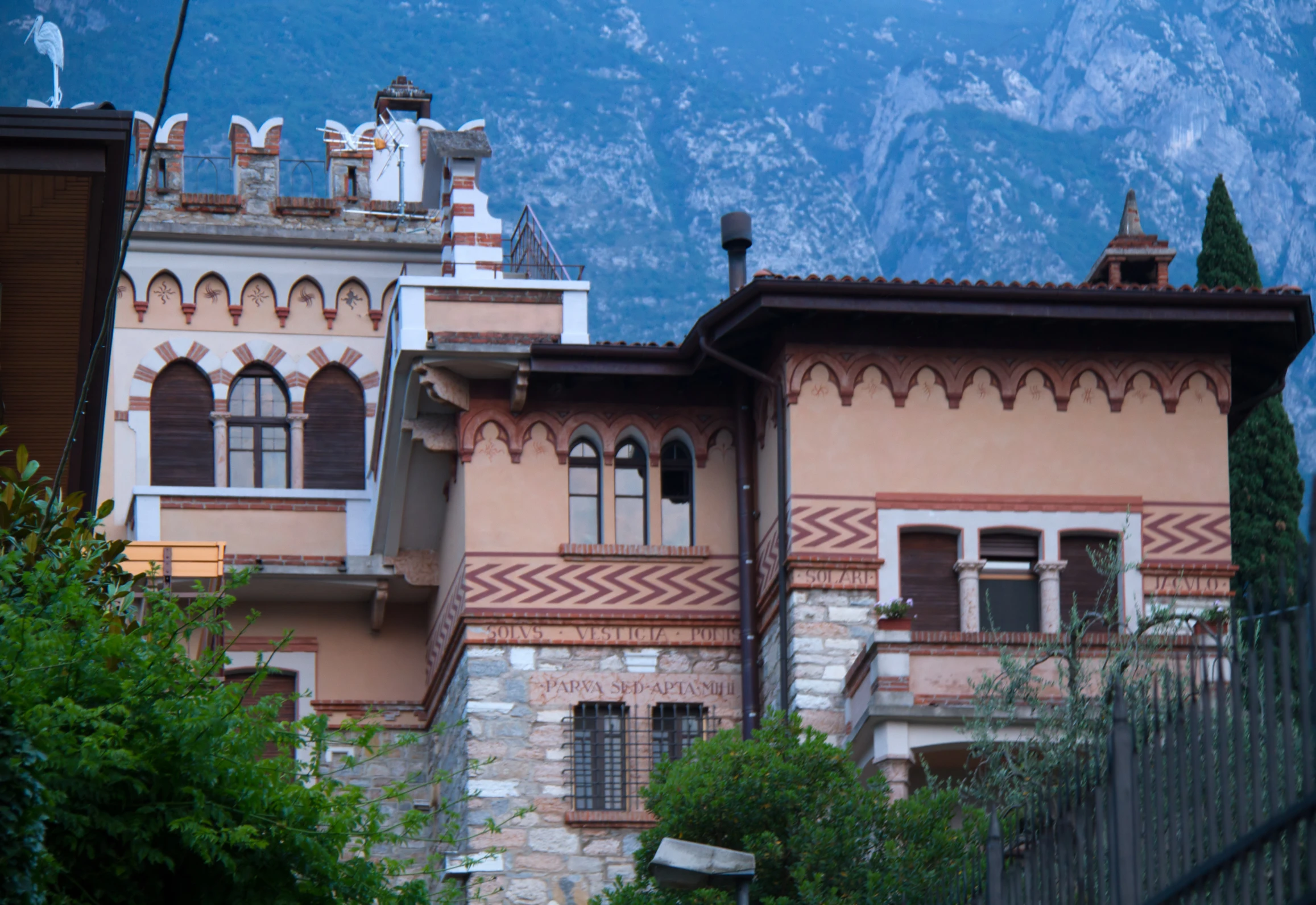 a very tall building with lots of windows next to mountains