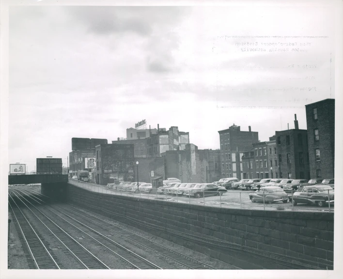 this is a black and white image of a train in a city