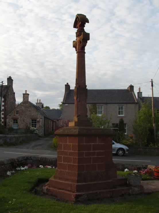 a stone monument with a hat on top of it